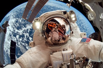 International Space Station and astronaut in outer space over th